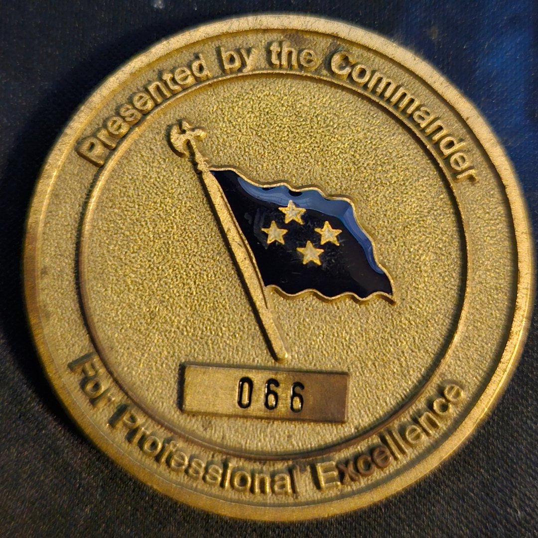 Reverse of the SOCOM commander coin reading Presented by the Commander, For Professional Excellence, with the four-star flag