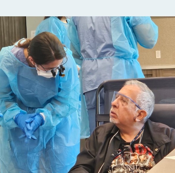 A veteran receiving dental care from a UCLA Dental Student Outreach Network clinician