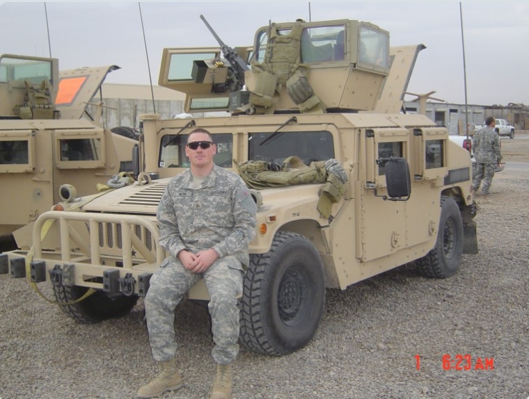 Ren H. Ross, U.S. Army, in ACU uniform seated on an up-armored Humvee while deployed in Iraq